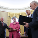 President Donald Trump (2nd R) watches as Jeff Sessions (L) is sworn-in as the new U.S. Attorney General by U.S. Vice President Mike Pence (R) in the Oval Office of the White House February 9, 2017 in Washington, DC. Trump also signed three executive orders immediately after the swearing in ceremony. Also pictured is Sessions’s wife, Mary (2nd L), holding the bible.